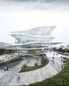 people are walking around in front of a large building with curved glass walls and stairs