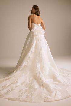 a woman in a white wedding dress is standing back to back with her hands on her hips