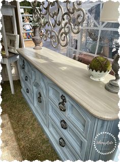 an old dresser is painted blue and white