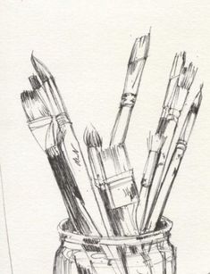 pencils and paintbrushes in a glass jar