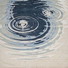 a blue and white rug with water ripples on it