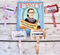 an image of a book and some toothbrushes on a wooden table with the title i dissent