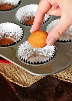 a person picking up some cupcakes from a muffin tin