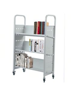 a metal book shelf with books on it and two rolling wheels in front of it