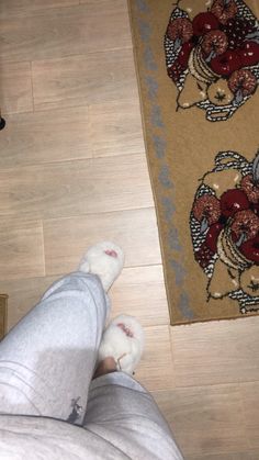 a person laying on the floor with their feet propped up in front of a rug