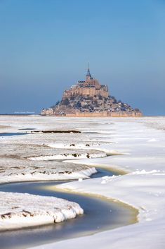 an island in the middle of some ice covered water