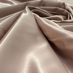 Introducing our gorgeous Satin Bridal Fabric - perfect for creating an exquisite wedding dress, evening gown, dance costume, or any other special occasion! Our stunning selection of 100% Polyester lace is the epitome of couture, designed to make your project extra special. Whether you’re looking for lace fabric for a quinceanera dress, an evening dress, or a dance costume, our selection of 17 different colors range from classic whites and ivories to bright and bold colors. Not only does this bri Elegant Stretch Wedding Gown, Elegant Gown With Satin Finish For Debutante Ball, Formal Beige Satin Gown, Beige Satin Wedding Gown, Elegant Blush Wedding Gown, Quinceanera Crown, Wedding Dress Evening, Satin Wedding Gown, For Wedding Dresses