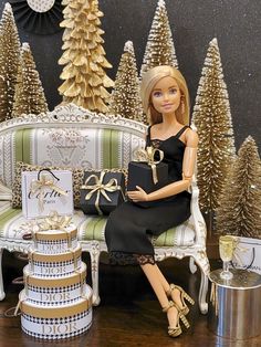 a barbie doll sitting on a couch next to christmas trees and presents in front of her