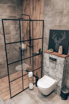 a bathroom with a shower, toilet and sink in it's stall area next to a tiled wall