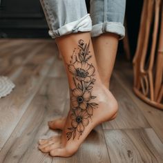 a woman's foot with a flower tattoo on her left side and right leg