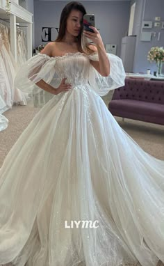 a woman taking a selfie in a wedding dress with her hands on her hips