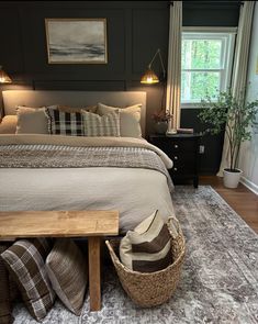 a bedroom with a large bed and two baskets on the floor next to each other