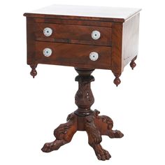 an old wooden table with two drawers on one side and three knobs on the other