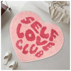 a pink heart shaped rug with the words cool love written on it