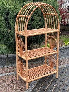 a bamboo birdcage is sitting on the ground