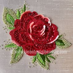 a red rose with green leaves and pearls on it's side is made out of beads