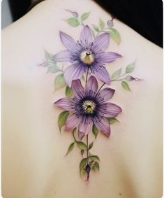 a woman's back with purple flowers on it