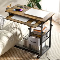 a laptop computer sitting on top of a wooden table next to a white couch in a living room