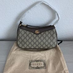 Brand New, Unused Beige And Ebony Gg Supreme Canvas Brown Leather Trim Cotton Linen Lining Double G Adjustable Top Handle With 7.5" Drop Top Zip Closure 9.8"W X 5.9"H X 2.5"D Made In Italy Brown Gucci Shoulder Bag With Top Carry Handle, Brown Gucci Shoulder Bag With Branded Hardware, Gucci Leather-lined Shoulder Bag For Shopping, Gucci Double Handle Bags With Gold-tone Hardware, Pre-owned Brown Gucci Bag, Drop Top, Leather Trims, Cotton Linen, Gucci Bag