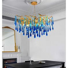 a chandelier hanging from the ceiling over a dining room table