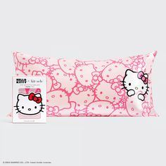 the hello kitty pillow is pink with white polka dots