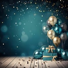 a blue box with gold and silver balloons in it on a wooden floor next to presents