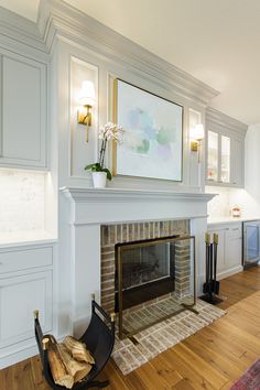 a living room filled with furniture and a fire place under a painting on the wall