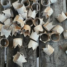 an old wooden table topped with lots of broken up pieces of tin foil on top of it