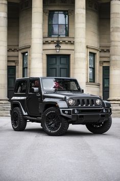 a black jeep parked in front of a large building with columns on the side of it