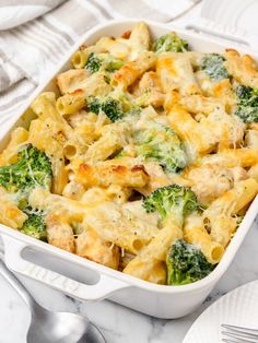 a casserole dish with broccoli and chicken in it on a table