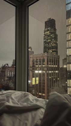 a view of the city at night from a hotel room window