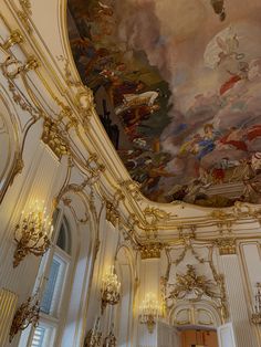 an ornate room with chandeliers and paintings on the ceiling