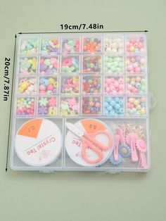 the plastic storage box has various beads and scissors in it