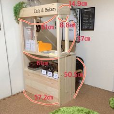 a wooden shelf with measurements for the top and bottom shelves in front of it on carpeted flooring