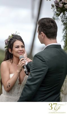 a man and woman standing next to each other holding a microphone in front of them