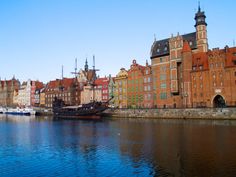 boats are parked on the water in front of old buildings