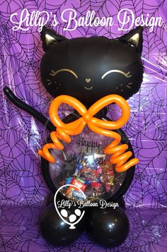 a black cat balloon with an orange bow on it's head and the words happy balloon design