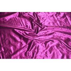 a purple sheet that is laying on top of a bed