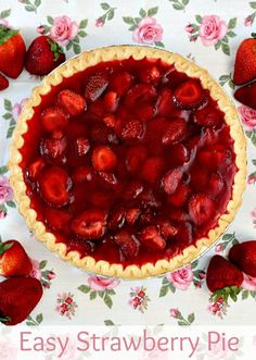 there is a pie with strawberries on the table