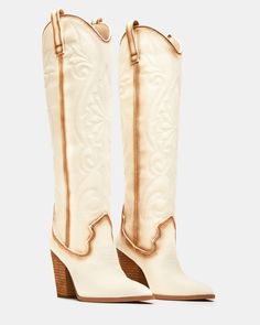 A Western boot is a requirement for any wardrobe and we’re obsessed with LASSO. This knee-high pair features whipstitching detail and a towering block heel. 3.75 inch heel height Size 6 measurements: 15 inch shaft circumference, 13.25 inch shaft height Size 8 measurements: 15.75 inch shaft circumference, 14.25 inch shaft height Size 10 measurements: 16.75 inch shaft circumference, 15 inch shaft height Textile upper material Textile and synthetic lining Synthetic sock Synthetic sole Imported Knee High Cowgirl Boots, High Cowgirl Boots, Denim Heels, Football Game Outfit, Western Boots Women, Western Boot, Comfortable Heels, Dress Sandals, Cowgirl Boots