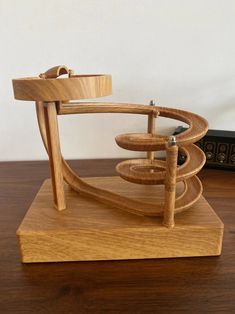 a wooden sculpture sitting on top of a table