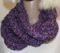 a close up of a mannequin wearing a purple knitted cowgirl scarf