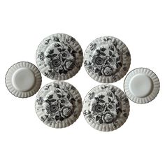 four black and white plates with flowers on them