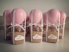 four jars with pink balloons tied to them