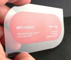 a person holding up a plastic business card