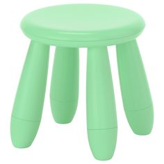 a green stool with three legs on it