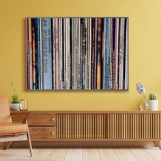 a room with a chair and a wall mounted to it's side, filled with books