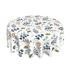 a round tablecloth with blue and yellow leaves on it, in front of a white background