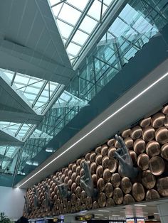 an airport lobby with lots of copper pots and pans hanging from the ceiling