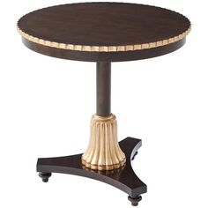 a wooden table with gold trimmings on the top and base, against a white background